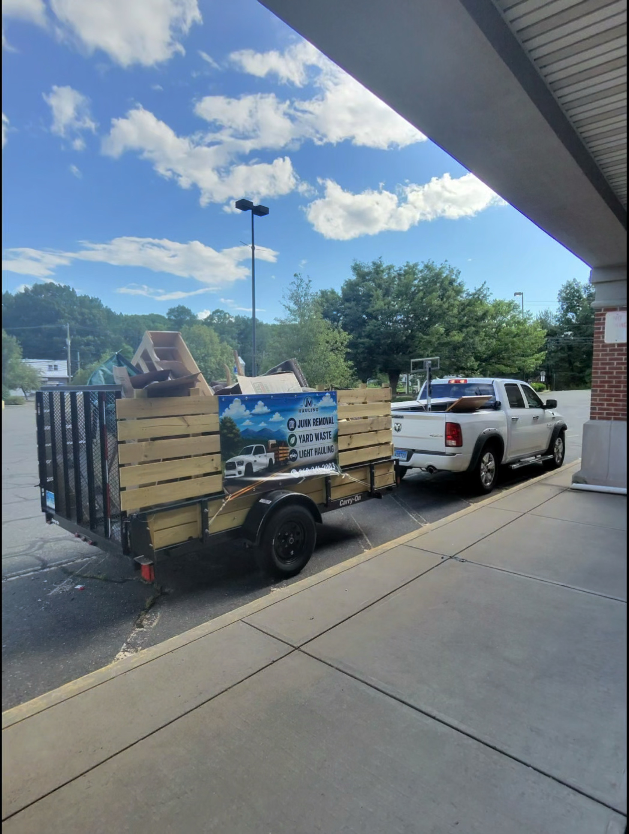 JM Hauling truck and trailer at a completed pickup