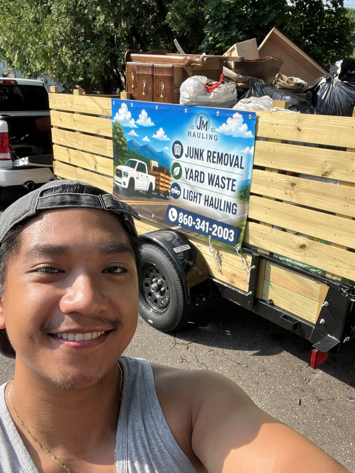 JM Hauling owner beside a loaded trailer
